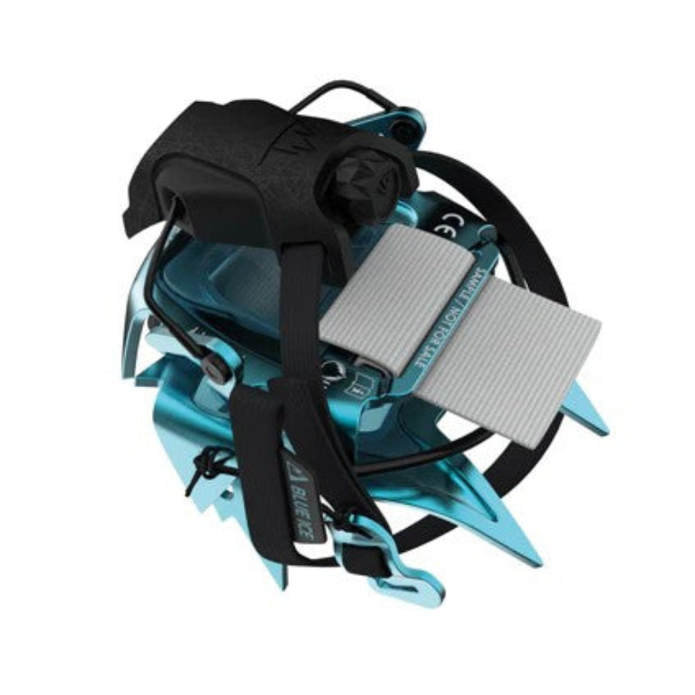 Turquoise climbing device with black straps on a white background