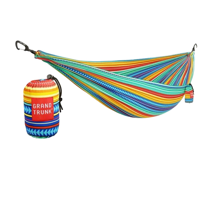 A colorful striped Trunk Tech single hammock by Grand Trunk, displayed with included lightweight aluminum carabiners and a packed stuff sack.