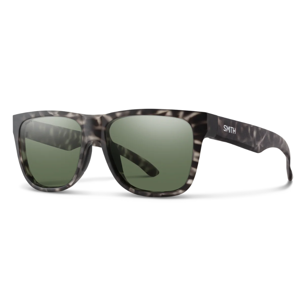 Sunglasses with tortoiseshell frame and green lenses on a white background