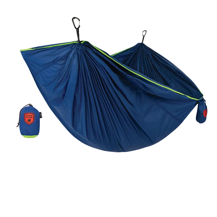 Blue hammock with green trim and a matching carrying bag on a white background