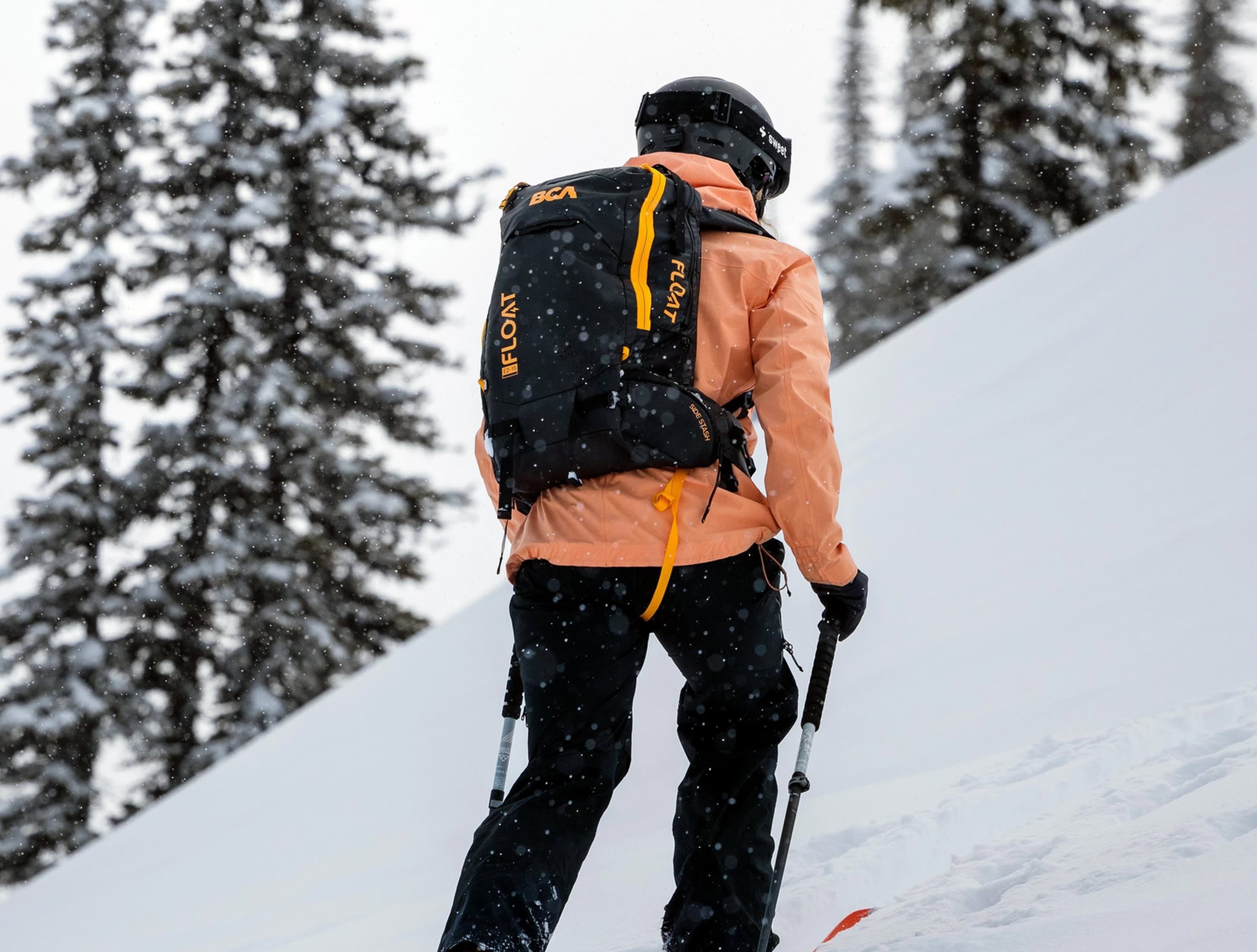 Person skiing in a snowy landscape with a backpack and ski poles