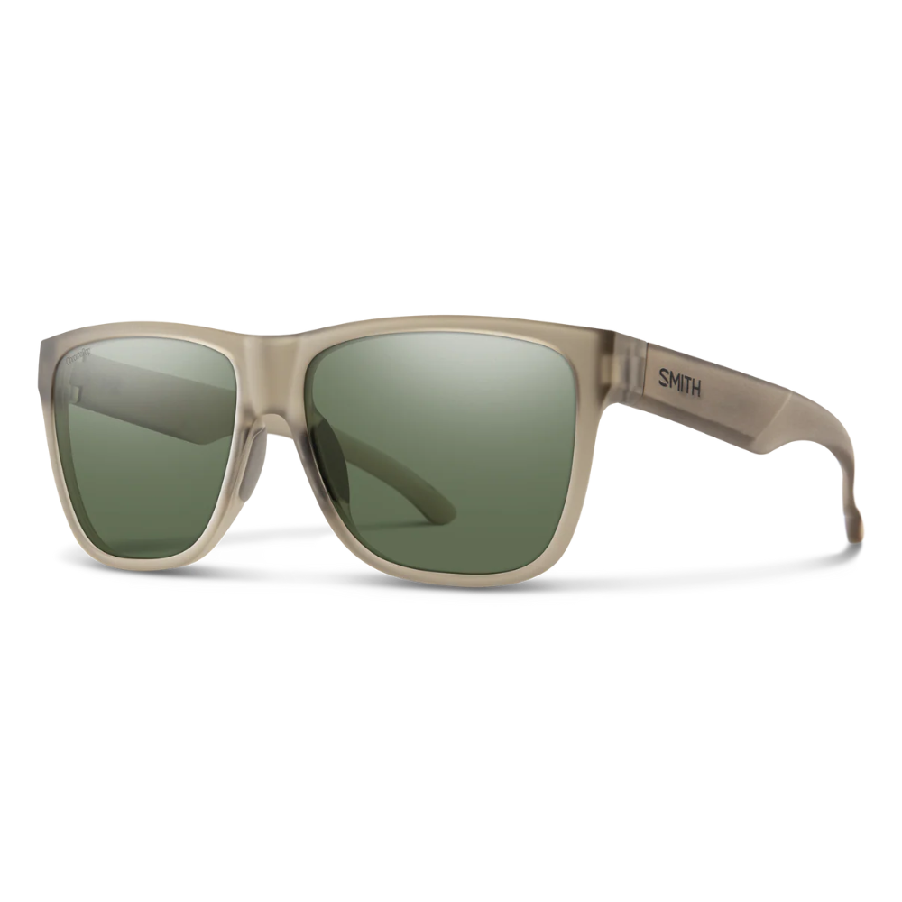 Sunglasses with green lenses and beige frame on a white background